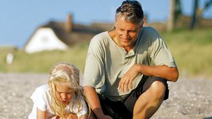 Grandpa and granddaughter in search of shells